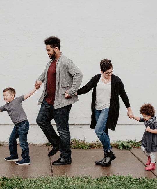 family walking on sidewalk